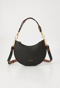Black semi-circular leather handbag with gold hardware, adjustable brown and black straps, and small gold brand logo on front.
