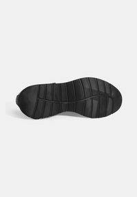 Black rubber shoe sole with textured surface, featuring horizontal and vertical grooves for grip and flexibility. Curved, rounded edge.