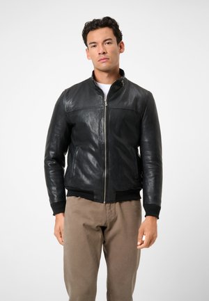 Black leather bomber jacket with a zip front, ribbed cuffs, and waistband. Smooth texture, fitted design, featuring side pockets.