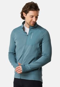 Sininen vetoketjuhuppari kevyestä kankaasta, jossa on tekstuuripinta, nostettava kaulus ja peukalonreiät hihoissa. Varustettu rintataskulla.