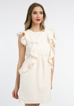 Short cream dress with ruffled sleeves, lace trim, and a gathered waist. Smooth texture and regular fit with side slits.