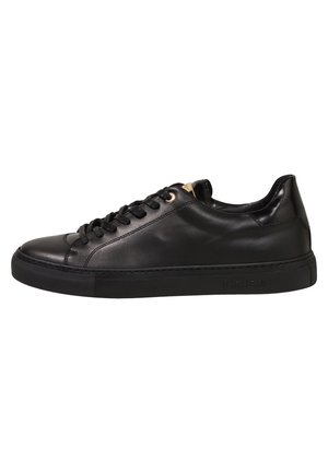 Black low-top leather sneaker with black laces and rubber sole, side profile on white background.