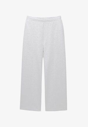 Weiße, weite Hosen aus weichem Stoff mit elastischem Bund und zwei Seitentaschen; glatte Textur und minimales Design.