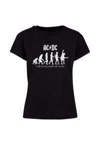 Schwarzes Baumwoll-T-Shirt mit weißen Drucken von Evolutionsfiguren und dem Text "AC/DC", Rundhalsausschnitt, kurzen Ärmeln und lässiger Passform.