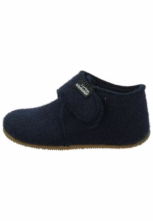 Chaussons en feutre bleu marine avec une sangle à velcro, bout arrondi et semelle en caoutchouc texturée pour une bonne adhérence. L'étiquette sur le côté indique "Living Kitzbühel."