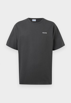 Σκούρο γκρι κοντομάνικη κοντή μπλούζα με λαιμόκοψη, με μικρό λευκό λογότυπο Columbia Sportswear στο αριστερό στήθος, σε απλό φόντο.