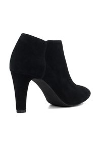 Black suede ankle boots with a pointed toe, 4-inch stiletto heel, and clean design. Features a smooth finish and no visible hardware.