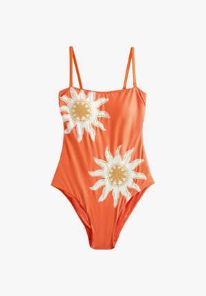 Costum de baie portocaliu întreg, cu bretele subțiri și două mari modele de soare brodate alb și auriu în față.