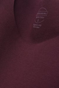 Burgundy cotton t-shirt featuring a v-neck design, smooth texture, and a printed label indicating size and origin.