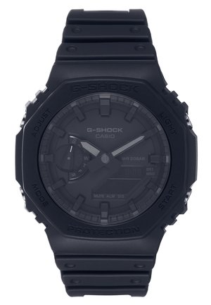Black G-Shock wristwatch with a matte finish, digital and analog display, textured bezel, and rubber strap. Water-resistant to 20 bar.