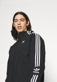 adidas Originals LOCK UPTT - Treniņjaka - black