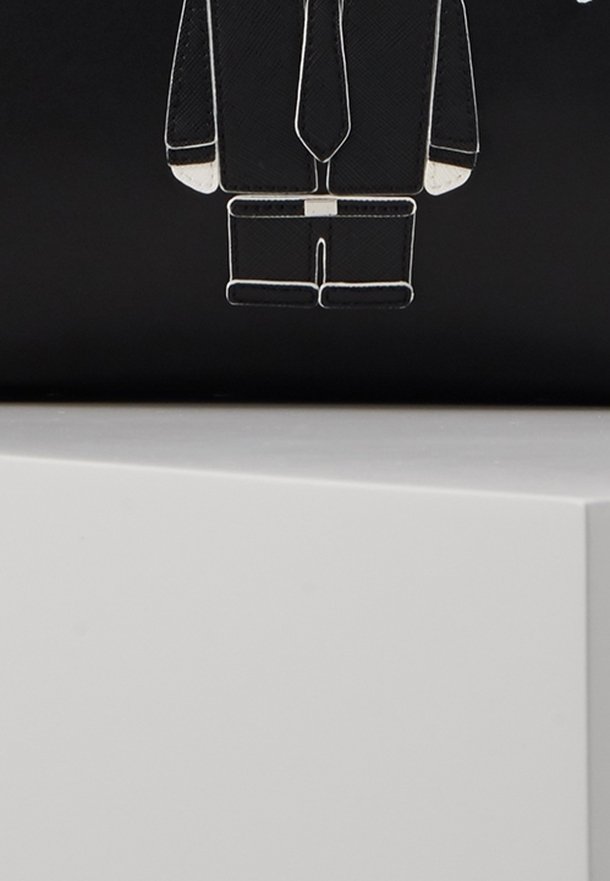 Black background featuring a white outline of a suit with a tie, illustrating a business attire design. The shape is rectangular and sleek.