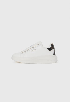 White leather sneakers with a textured brown accent at the heel, featuring gold eyelets and a raised sole. Brand name "GUESS" embossed on the side.