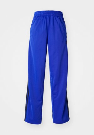 Pantalon de sport bleu avec taille élastique, doté de rayures latérales noires, coupe ample et texture lisse.