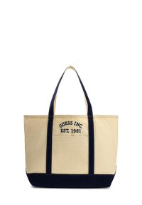 Borsa a spalla in tela beige con dettagli e manici blu navy. Presenta il testo ricamato "GUESS INC. EST. 1981" sul fronte. Forma strutturata.