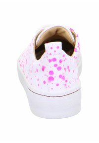 White sneaker with pink splatter design, slip-on style, padded collar, and textured rubber sole. Clean, modern aesthetic.