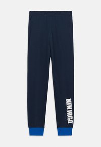 Navy modré tepláky vyrobené z mäkkej tkaniny; elastický pás; modré manžety na členkoch; na ľavej nohe sa nachádza biele text "Ninjago".