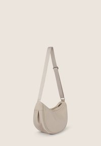 Borsa a spalla in tessuto beige con forma curva, tracolla regolabile e chiusura con zip. Texture liscia con dettagli di cucitura sottili.