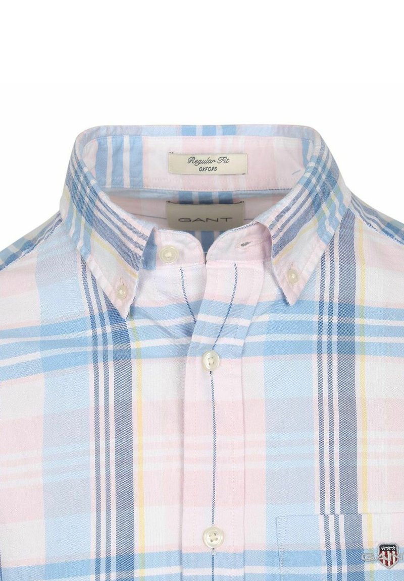 Buttoned collar shirt with blue, pink, white, and yellow plaid pattern, labeled regular fit Oxford by GANT with a small embroidered logo on the pocket.