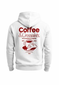 White hoodie featuring red graphic design of a coffee cup and croissant, with text "Coffee & Croissants. the breakfast of legends. EST. 2025."
