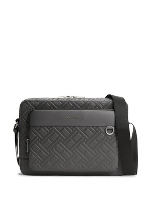 Schwarze Tommy Hilfiger Crossbody-Tasche mit geprägtem geometrischem Muster, vorderer Reißverschlusstasche, silberner Hardware und verstellbarem Schulterriemen.