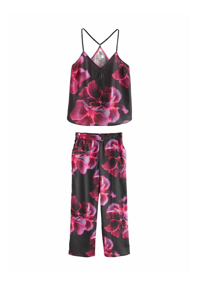 Set format doua piese cu un model floral, având o bază neagră cu flori mari roz, un top fără mâneci cu bretele ajustabile și pantaloni cu croi lejer.