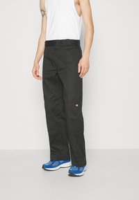 Black pants with a straight fit, made of durable material. Features a waistband with belt loops and a logo on the upper thigh.
