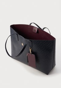 Duża granatowa torba tote o teksturowanej powierzchni, burgundowe wnętrze, podwójne uchwyty i złote logo. Zawiera pasujący, odpinany portfel na karty.