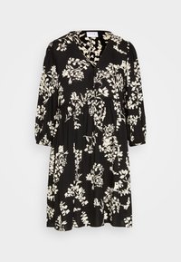 Robe noire à manches trois-quarts, ornée d'un motif floral blanc. Design en V avec une taille froncée, silhouette fluide.