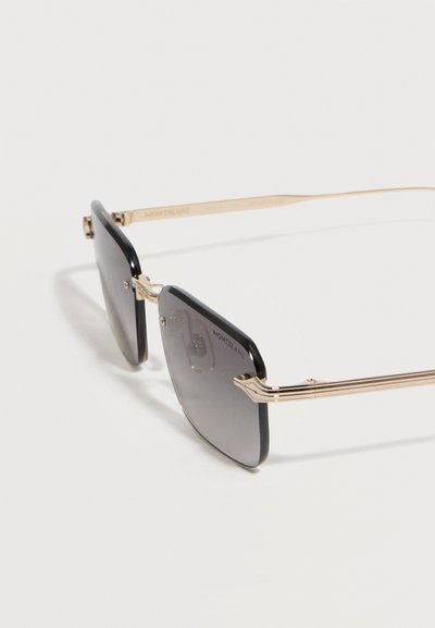 Μαύρα γυαλιά ηλίου με τετράγωνο πλαίσιο, φακούς με βαθμιαία σκουρότητα και λεπτούς μεταλλικούς βραχίονες σε χρυσό χρώμα, με το λογότυπο Montblanc στον φακό.