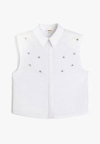 Blusa bianca senza maniche con colletto a punta, caratterizzata da decorative triangolari argentate distribuite uniformemente sulla parte anteriore. Tessuto dalla superficie liscia.