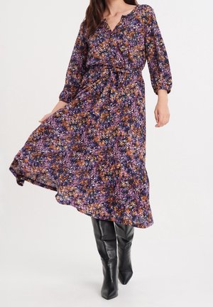Robe midi florale avec des motifs violets, oranges et roses. Dotée d'un col en V, de manches trois-quarts et d'une taille nouée, fabriquée en tissu léger.