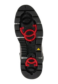 Black sole with textured pattern, featuring red and black circular hardware and yellow accent detailing. Durable material designed for grip.