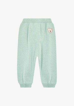 Miętowo-zielone, dziergane spodnie z elastycznym pasem, marszczonymi mankietami przy kostkach oraz małą aplikacją niedźwiadka z przodu. Gładka faktura i swobodny styl.