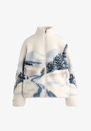 Fleece bunda s vysokým golierom, v krémovej farbe, s dizajnom krajiny v modrej a šedej farbe, na ktorom sú stromy a krivolaká cesta. Podrobnosť o vrecku na zips.