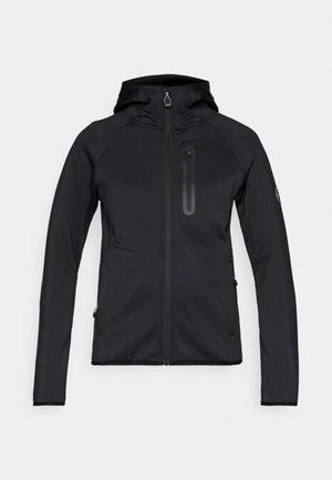 Crna dukserica s kapuljačom i uskim krojem, izrađena od mekanog, rastezljivog materijala. Ima džepove s patentnim zatvaračem i glatku teksturu.