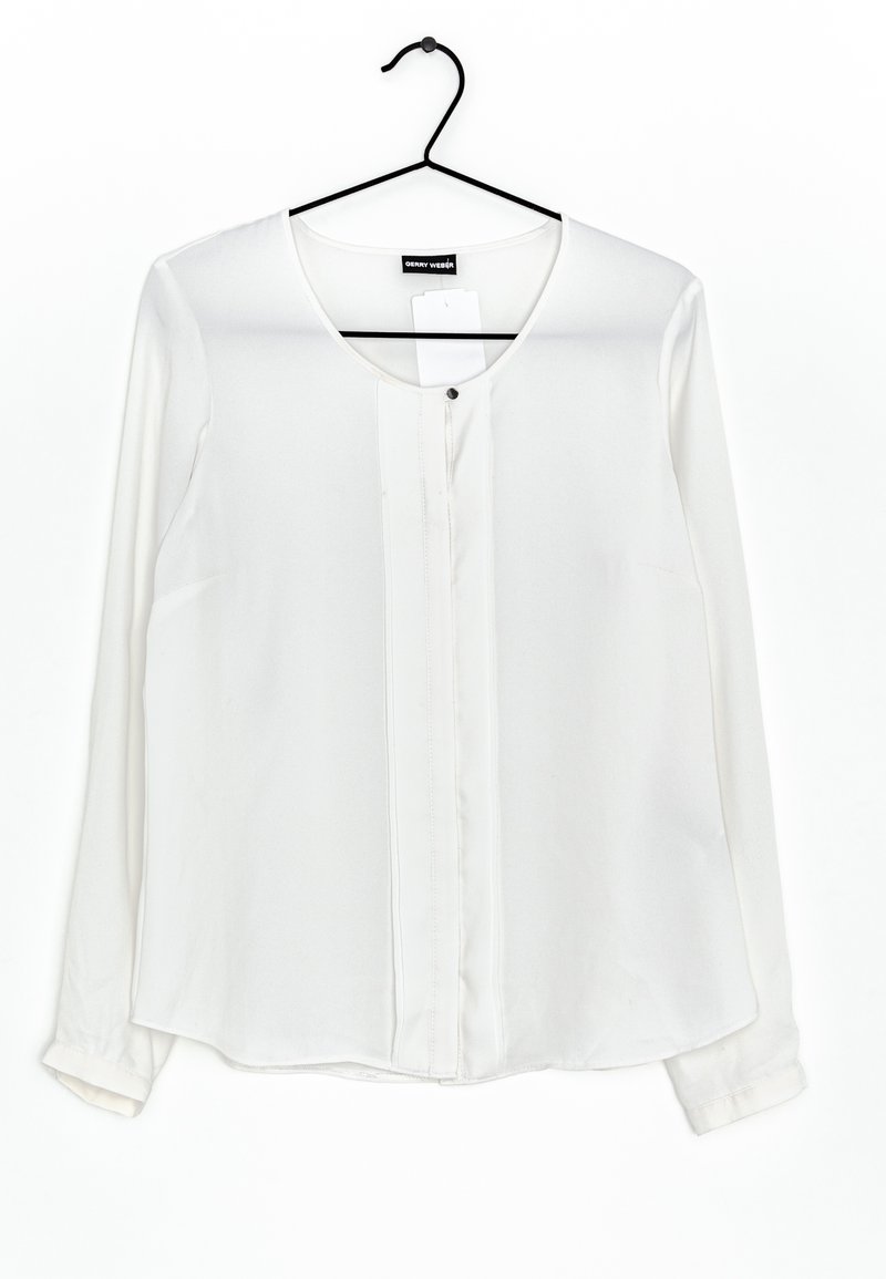 Blusa bianca a maniche lunghe con scollo tondo, chiusura frontale con bottoni e leggera lucentezza. Realizzata in tessuto liscio con orlo curvo.