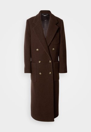 Ruskea villakangastakki, jossa on kaksirivinen malli, suuret kaulukset, neljä etutaskua ja kultasävyiset napit. Pitkä malli, jossa on sileä vuori.