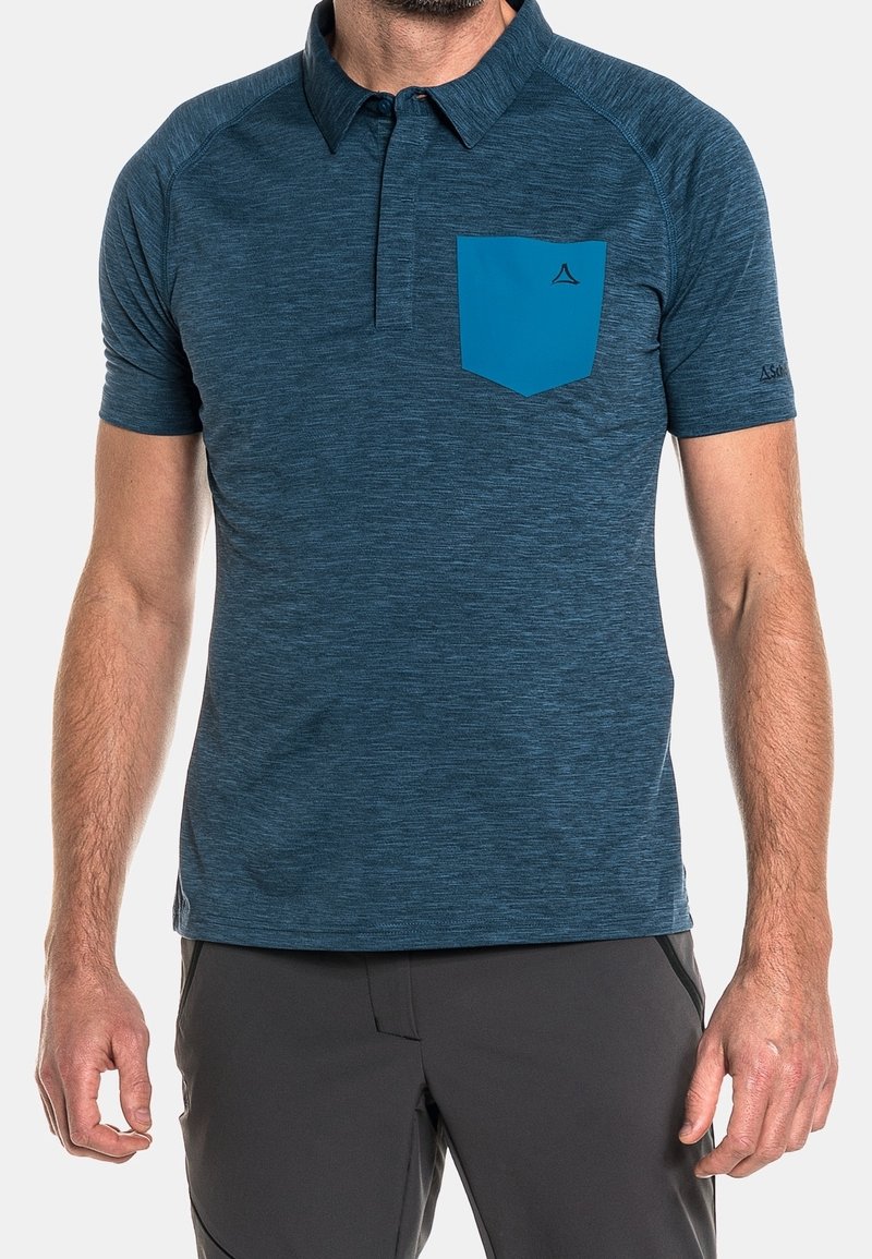 Kortärmad polo-tröja i mörkblått, tillverkad av strukturerat material. Har en kontrasterande blå bröstficka och en standard kragdesign.