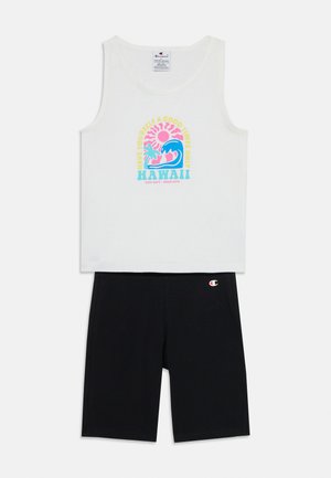 Top bianco senza maniche con una grafica colorata "Hawaii" e un design a onda, abbinato a pantaloni neri aderenti, entrambi realizzati in un tessuto morbido.