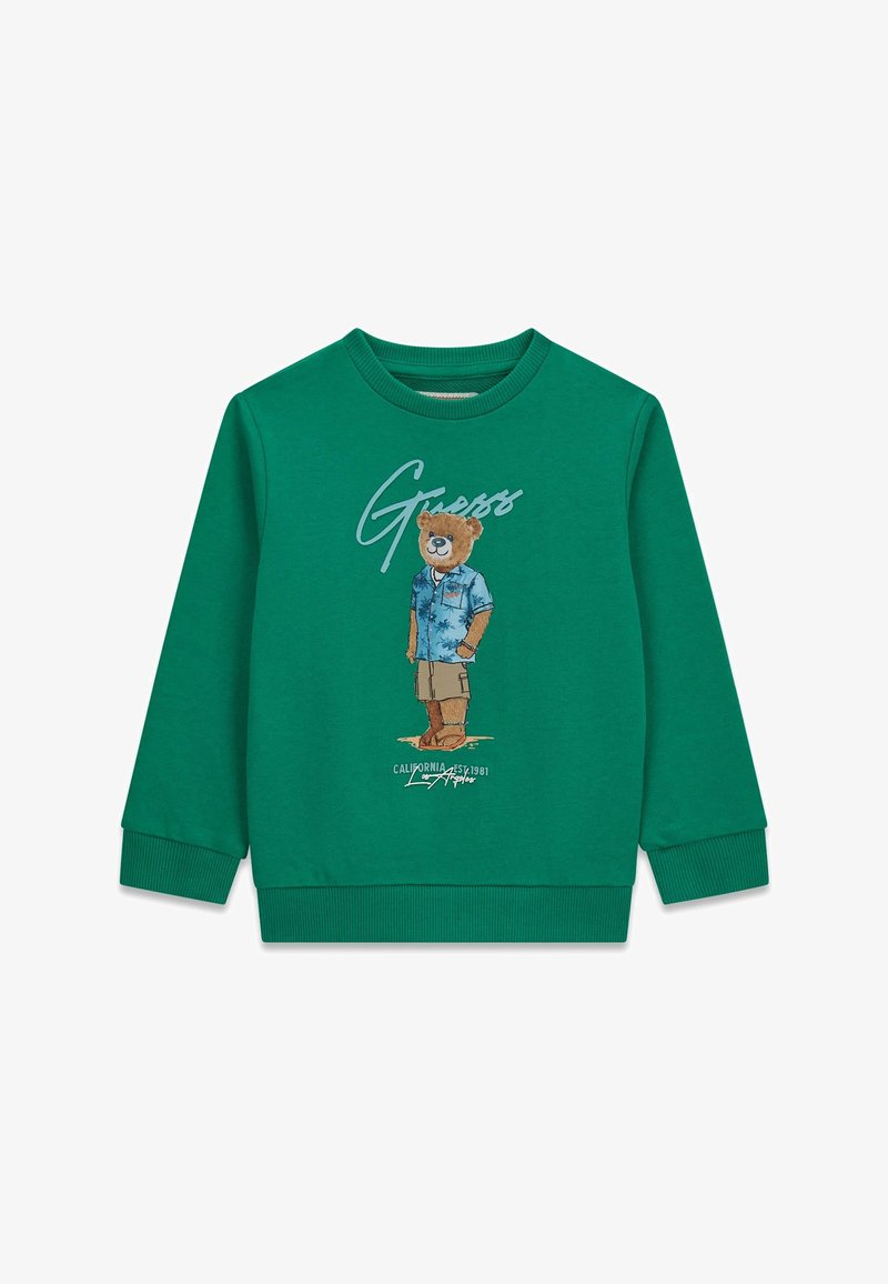 Grüner Langarm-Sweatshirt mit einer Grafik eines Bären, der ein blaues Hemd, beige Shorts und Sandalen trägt, mit dem Schriftzug "Guess" darüber.