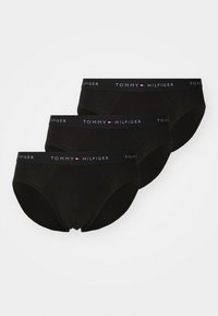 Schwarzes Baumwoll-Unterwäscheset mit drei Paar, jeweils mit einem elastischen Bund, der "TOMMY HILFIGER" in weißem Text zeigt.