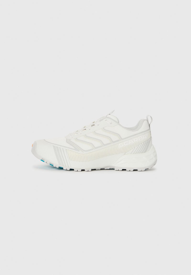 Weißer Sportschuh mit strukturiertem Obermaterial, das schmale Streifen und eine verstärkte Zehenpartie aufweist. Die Außensohle verfügt über multidirektionale Stollen für besseren Halt.