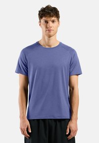 Men's short-sleeved T-shirt in a solid purple color. Made of a smooth, lightweight fabric with a round neck and raglan sleeves.
