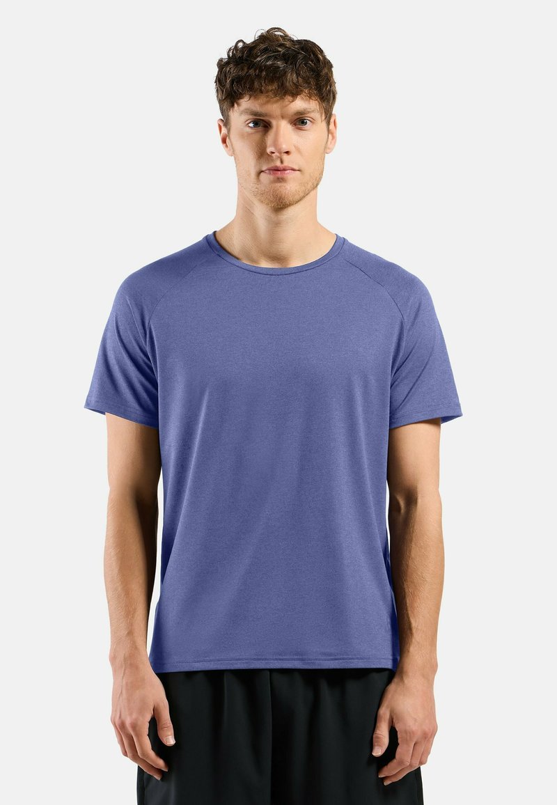 Men's short-sleeved T-shirt in a solid purple color. Made of a smooth, lightweight fabric with a round neck and raglan sleeves.