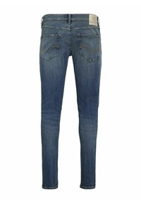 Jeans ajustados en denim azul deslavado. Presentan una cintura de altura media, bolsillos traseros con costuras curvas y una etiqueta tejida en la parte posterior de la cinturilla.