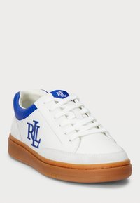 Vit sneaker med blå accenter, med en texturerad ovandel, gummisula och präglat märke på sidan. Snören och vadderad krage ingår.