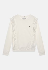 Bílý dlouhý rukáv mikina s řasenými detaily po stranách, elastickým lemem a malým logem na hrudi. Měkká bavlněná tkanina.