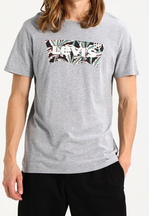 Grå bomuld T-shirt med et farverigt, blomsterdekoreret Levi's-logo på brystet, rund hals og korte ærmer.