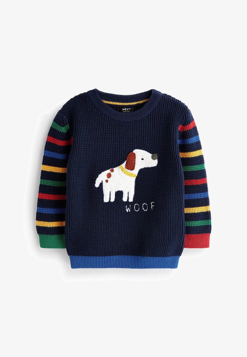Pull en maille bleu marine avec manches rayées multicolores, présentant un chien blanc à taches brunes et le texte « woof » sur le devant.